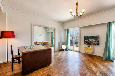 an empty living room with a desk and a table at Amazing Penthouse in Athens city center in Athens