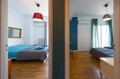 a room with two beds and a room with a bedroom at Amazing Penthouse in Athens city center in Athens
