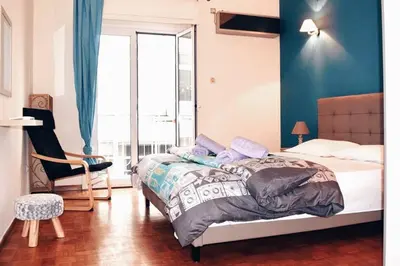 a bedroom with a bed and a blue wall at Athens Central 2BD Apartment at Acropolis Plaka in Athens