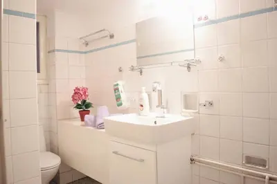a white bathroom with a sink and a toilet at Athens Central 2BD Apartment at Acropolis Plaka in Athens