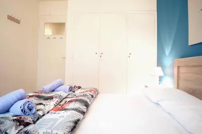 a bedroom with a bed and white cabinets at Athens Central 2BD Apartment at Acropolis Plaka in Athens