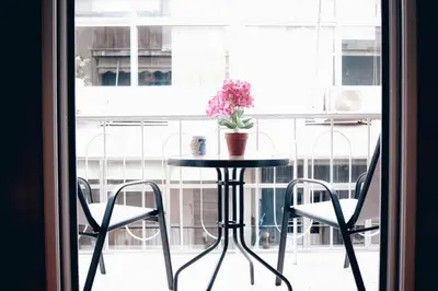 a table with a potted plant sitting on top of a window at Athens Central 2BD Apartment at Acropolis Plaka in Athens