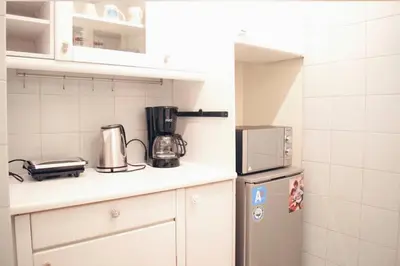 a kitchen with a refrigerator and a microwave at Athens Central 2BD Apartment at Acropolis Plaka in Athens