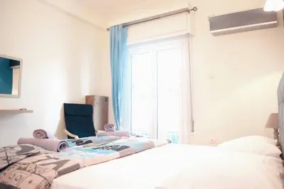 a bedroom with a bed and a large window at Athens Central 2BD Apartment at Acropolis Plaka in Athens