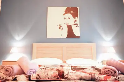 a bedroom with a bed with a picture on the wall at Athens Central 2BD Apartment at Acropolis Plaka in Athens
