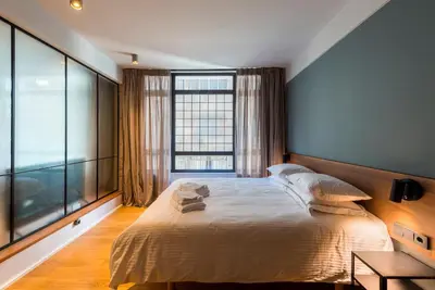 a bedroom with a large bed and a large window at Kin Athens in Athens