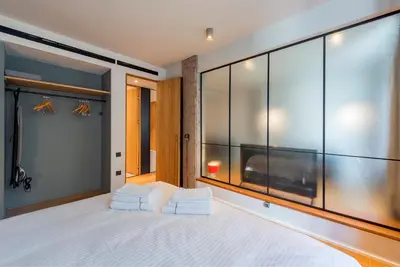 a bedroom with a large bed with two white towels at Kin Athens in Athens