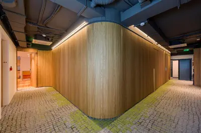 a large wooden wall in a room with a tile floor at Kin Athens in Athens