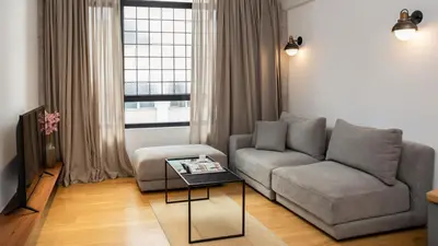 a living room with a couch and a table at Kin Athens in Athens