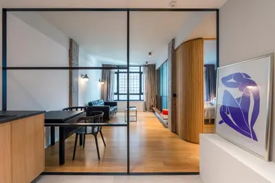a dining room and living room with glass walls at Kin Athens in Athens