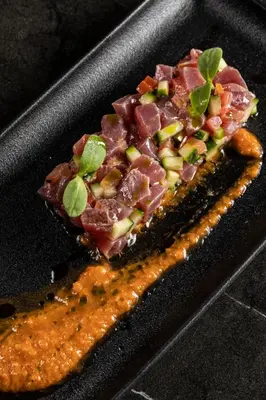 a piece of food on a black plate at Heritage Hill Hotel in Athens