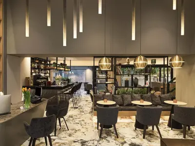 a restaurant with tables and chairs and a bar at Heritage Hill Hotel in Athens