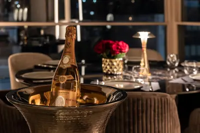 a bottle of champagne in a metal bucket on a table at Heritage Hill Hotel in Athens