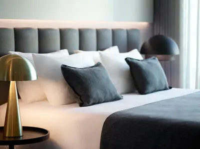 a bedroom with a large bed with white pillows at Heritage Hill Hotel in Athens
