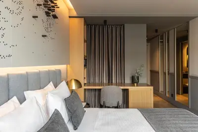 a hotel room with a bed and a desk at Heritage Hill Hotel in Athens