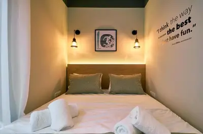 a bedroom with a bed with two towels on it at “Olympic Spirit” Apt in N. Kosmos neighbourhood in Athens