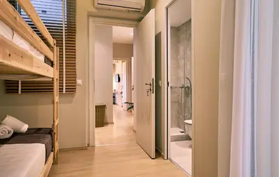 a bedroom with a bunk bed and a walk in shower at “Olympic Spirit” Apt in N. Kosmos neighbourhood in Athens