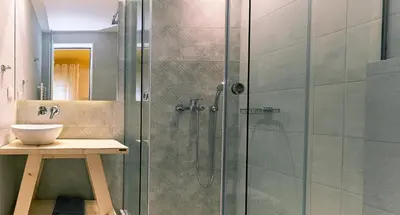 a bathroom with a glass shower with a sink at “Olympic Spirit” Apt in N. Kosmos neighbourhood in Athens