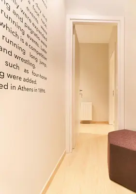a room with a bed and words on the wall at “Olympic Spirit” Apt in N. Kosmos neighbourhood in Athens