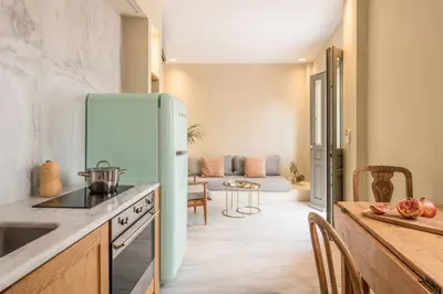 a kitchen with a refrigerator and a dining room at Anafiotika hideaway acropolis Athens by Cycladica in Athens