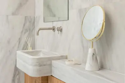a white bathroom with a sink and a mirror at Anafiotika hideaway acropolis Athens by Cycladica in Athens