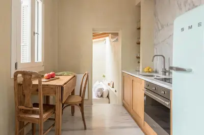 a kitchen with a wooden table and a dining room at Anafiotika hideaway acropolis Athens by Cycladica in Athens