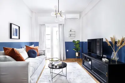 a living room with a couch and a tv at Divine 1BR Apartment near the Acropolis museum in Athens
