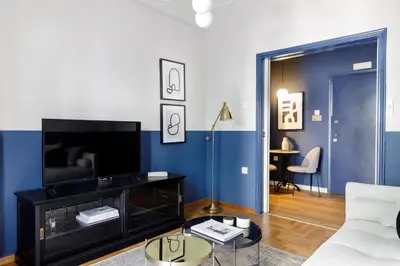 a living room with a couch and a tv at Divine 1BR Apartment near the Acropolis museum in Athens