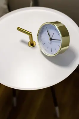 a clock sitting on top of a white table at Divine 1BR Apartment near the Acropolis museum in Athens