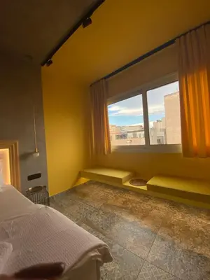 a bedroom with a bed and a large window at La mouette apartment,Plaka, Athens in Athens