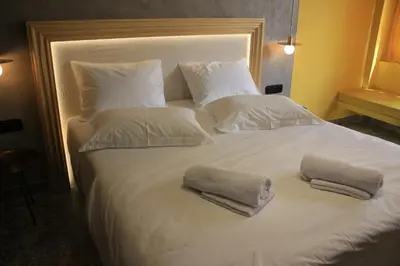a large white bed with two pillows on it at La mouette apartment,Plaka, Athens in Athens