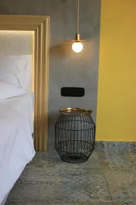 a bedroom with a bed and a basket table at La mouette apartment,Plaka, Athens in Athens
