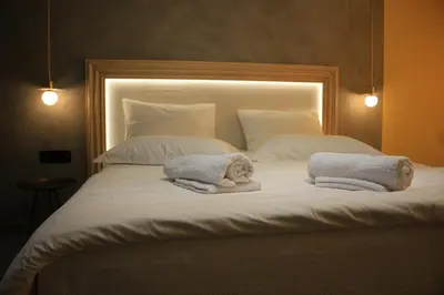 a large white bed with two towels on it at La mouette apartment,Plaka, Athens in Athens