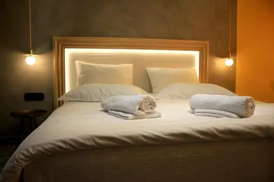 a large bed with two towels on top of it at La mouette apartment,Plaka, Athens in Athens
