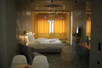 a bedroom with a bed and a table and chairs at La mouette apartment,Plaka, Athens in Athens