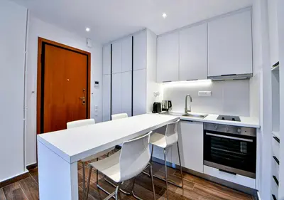 a kitchen with white cabinets and a white counter top at Boutique40 Luxury Apartment in Athens