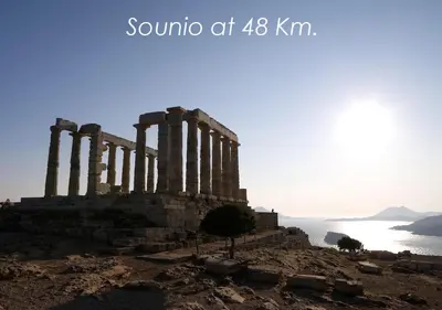 a temple on a hill next to the ocean at Boutique40 Luxury Apartment in Athens
