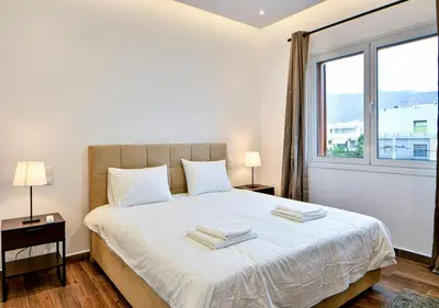 a bedroom with a large bed with two towels on it at Boutique40 Luxury Apartment in Athens