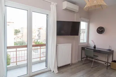 a room with a desk and a large window at Gazi District Next To Subway 2 in Athens