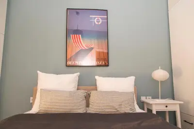 a bedroom with a bed with a picture on the wall at Gazi District Next To Subway 2 in Athens