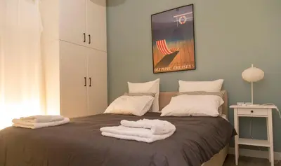 a bedroom with a bed with towels on it at Gazi District Next To Subway 2 in Athens