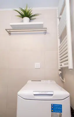 a toilet in a bathroom with a plant on the wall at Gazi District Next To Subway 2 in Athens