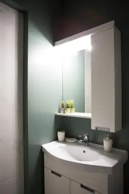 a bathroom with a white sink and a mirror at Mosaics aprtm in Parliament square with Acropolis View in Athens