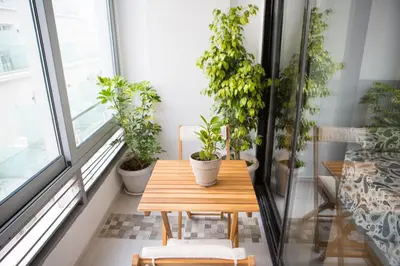 a table and chairs in a room with potted plants at Mosaics aprtm in Parliament square with Acropolis View in Athens