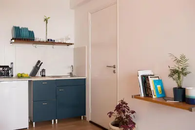 a kitchen with a blue cabinet and a sink at Mosaics aprtm in Parliament square with Acropolis View in Athens