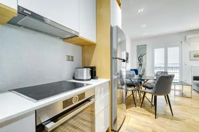 a kitchen and dining room with a table and chairs at Stylish, Sunny New 2 Bedroom, Prime Central Athens in Athens