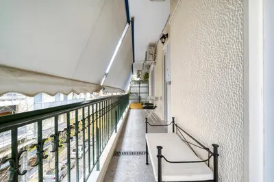 a corridor of a building with a bench on a balcony at Stylish, Sunny New 2 Bedroom, Prime Central Athens in Athens