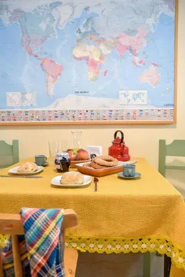 a table with food and a map on the wall at Homie Apartment next to Acropolis in Athens