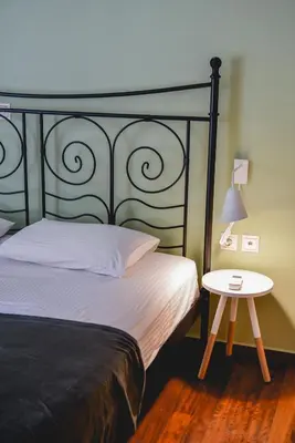 a bedroom with a bed and a side table at Homie Apartment next to Acropolis in Athens