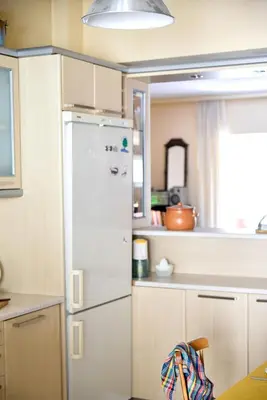 a kitchen with a white refrigerator and a window at Homie Apartment next to Acropolis in Athens